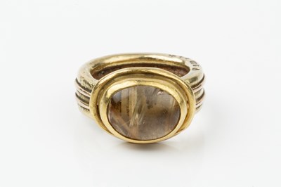 Lot 185 - An 18ct gold and rutilated quartz set ring,...