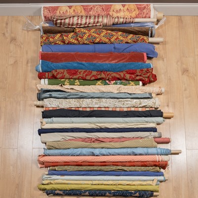 Lot 424 - A collection of various rolls of upholstery material