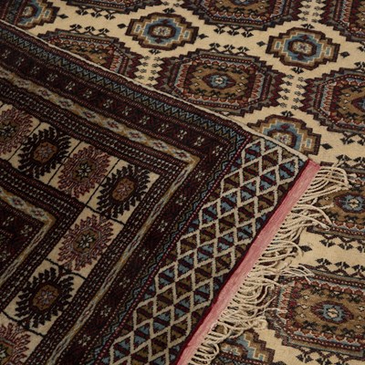 Lot 36 - Afghan sofa carpet of cream/ivory ground with...