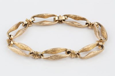 Lot 121 - A 9ct gold bracelet, formed of shaped and...