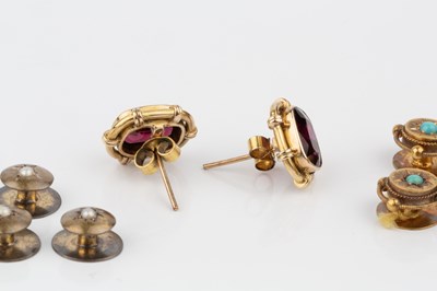 Lot 122 - A pair of garnet ear studs, in unmarked yellow...