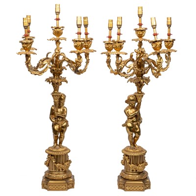 Lot 302 - A pair of ormolu four-branch electrified candelabra