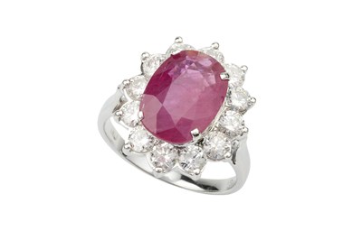 Lot 191 - A ruby and diamond cluster ring, the oval...
