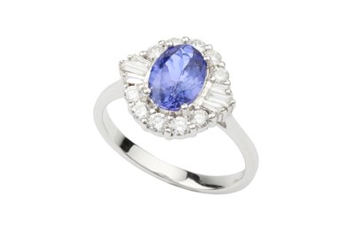 Lot 241 - A tanzanite and diamond cluster ring, the oval...