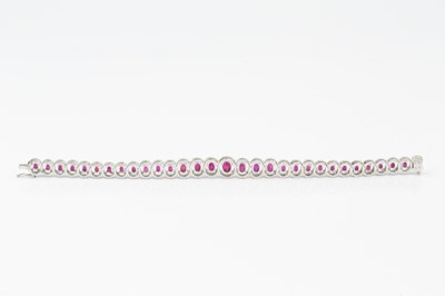 Lot 192 - A ruby and diamond cluster line bracelet,...