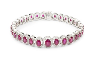 Lot 192 - A ruby and diamond cluster line bracelet,...
