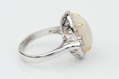 Lot 153 - An opal and diamond dress ring, the oval...