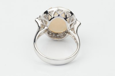Lot 153 - An opal and diamond dress ring, the oval...