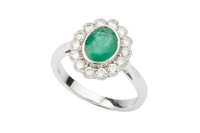 Lot 332 - An emerald and diamond dress ring, the oval...