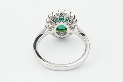Lot 332 - An emerald and diamond dress ring, the oval...