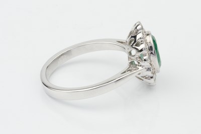 Lot 332 - An emerald and diamond dress ring, the oval...