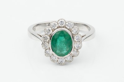 Lot 332 - An emerald and diamond dress ring, the oval...