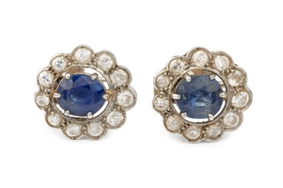 Lot 235 - A pair of sapphire and diamond cluster ear...