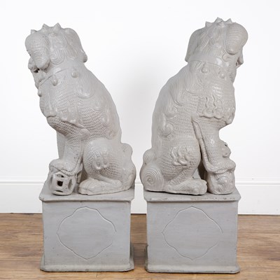 Lot 84 - Two large off-white glazed temple dogs in the...