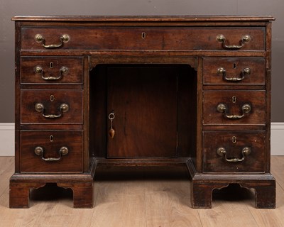 Lot 321 - A George III mahogany knee hole desk