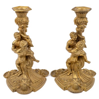 Lot 305 - A pair of French gilt candlesticks after a design by Meissonnier