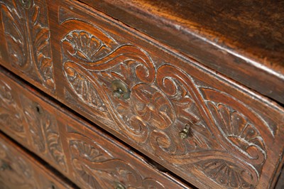 Lot 82 - An antique carved elm chest of drawers