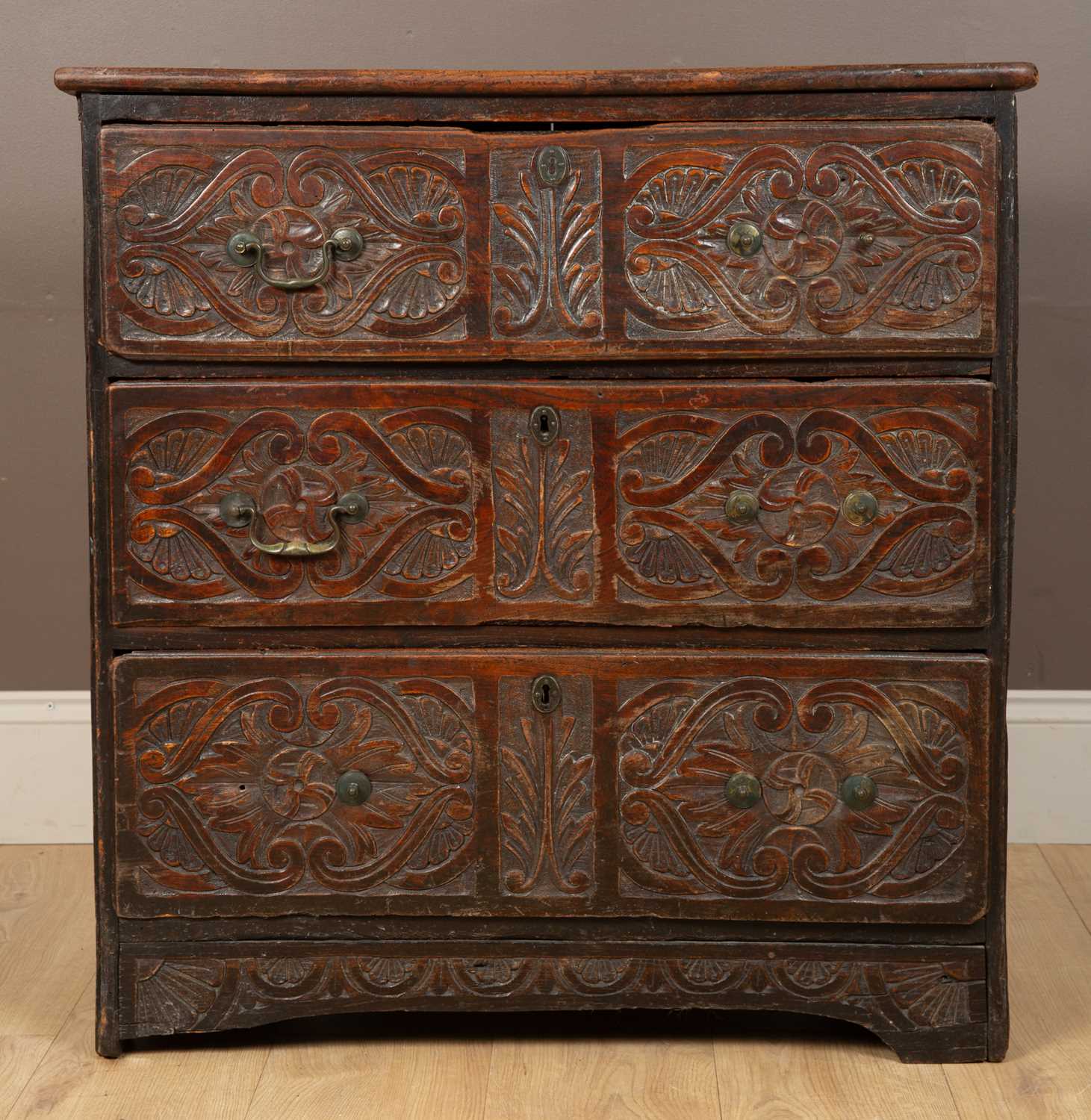 Lot 82 - An antique carved elm chest of drawers