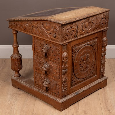 Lot 469 - An ornately carved Victorian oak Davenport