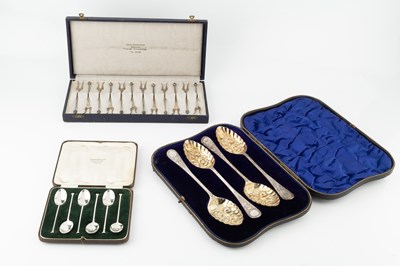 Lot 835 - A set of four Edwardian silver berry spoons,...