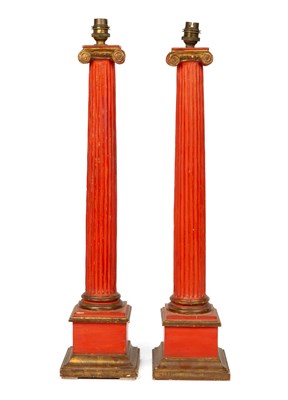 Lot 1022 - A pair of red painted table lamps