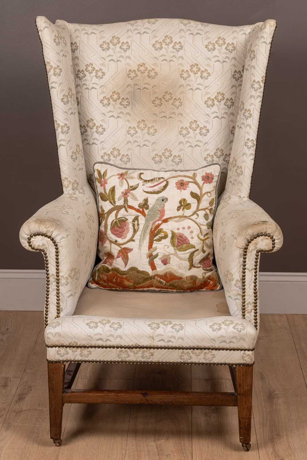 Lot 487 - A Georgian style wingback armchair