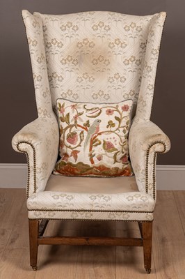 Lot 487 - A Georgian style wingback armchair