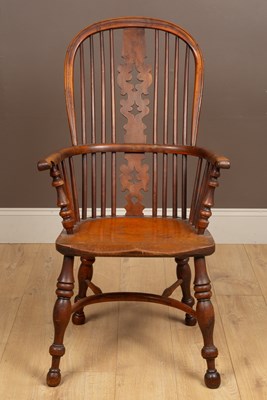 Lot 1003 - A 19th century yew wood high-back Windsor armchair