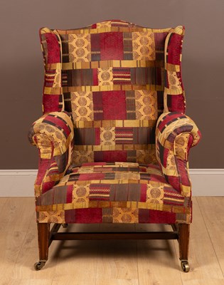 Lot 297 - A 19th century wingback armchair