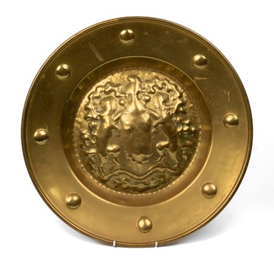 Lot 1002 - A brass armorial alms dish