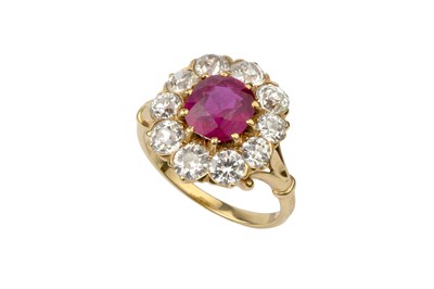 Lot 311 - A ruby and diamond cluster ring, the central...