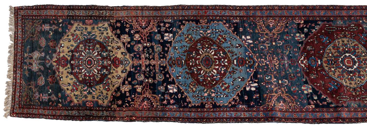 Lot 1090 - An early 20th century hand-woven Heriz runner