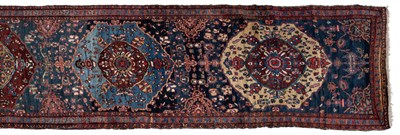 Lot 1090 - An early 20th century hand-woven Heriz runner