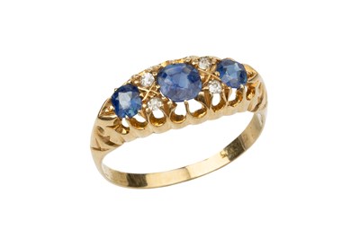 Lot 267 - A sapphire and diamond dress ring, the three...