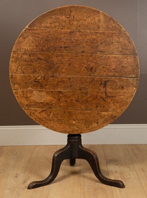 Lot 1035 - A 19th century elm country-made tilt-top tripod table