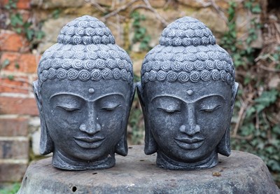 Lot 1197 - A pair of cast reconstituted stone Buddha heads