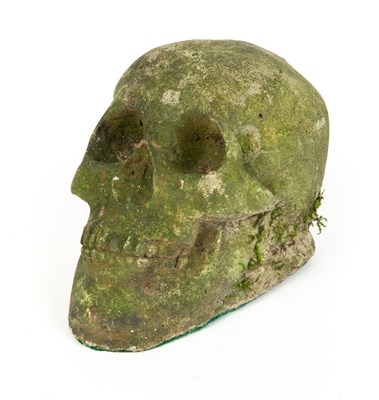 Lot 257 - A weathered composite stone skull