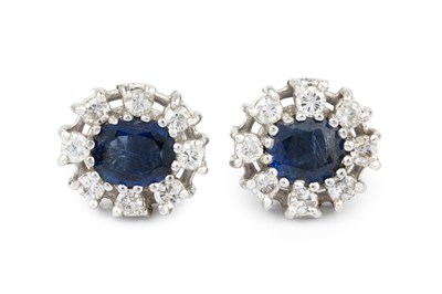 Lot 323 - A pair of sapphire and diamond cluster ear...