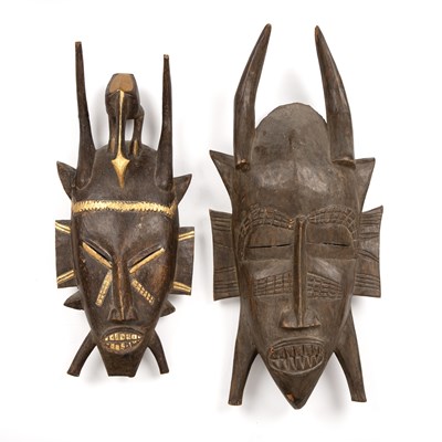 Lot 102 - Two carved hardwood African masks, one with...