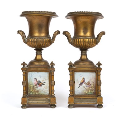 Lot 256 - A pair of brass urns on square plinth bases