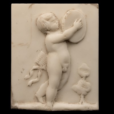 Lot 1231 - A marble tablet of Venus and Cupid together with a pair of marble plaques of putti