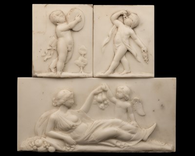 Lot A marble tablet of Venus and Cupid together with a pair of marble plaques of putti