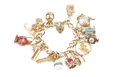 Lot 334 - A 9ct gold curb link charm bracelet, with...