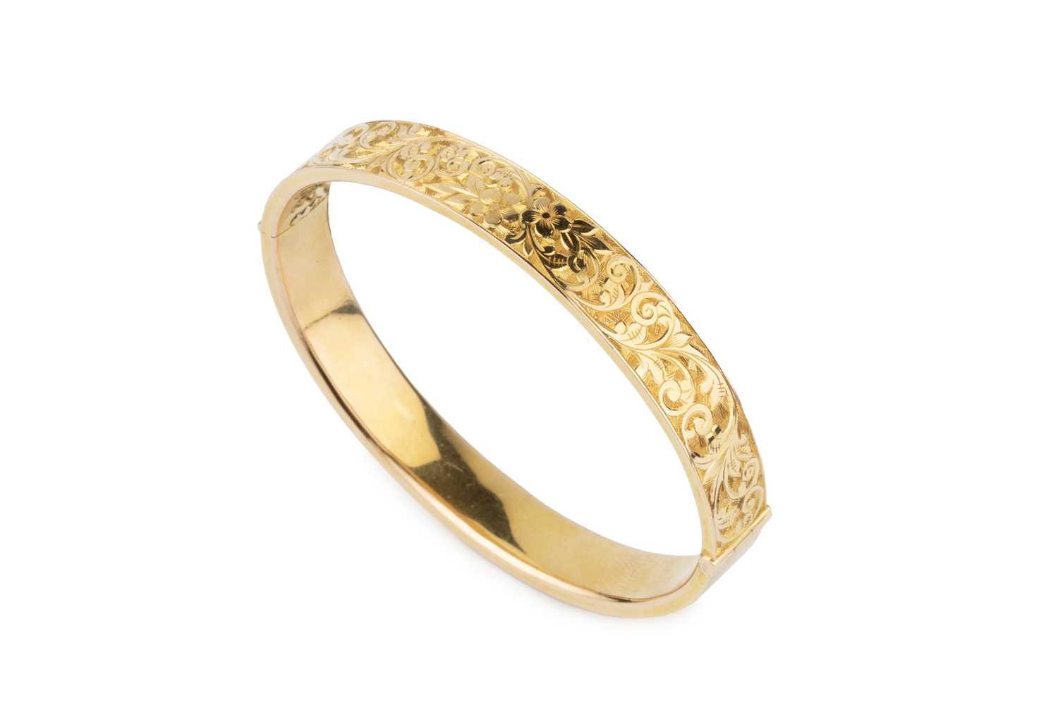 Lot A 15ct gold oval hinged bangle, engraved with...