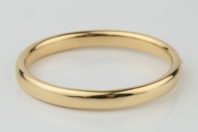 Lot A French yellow gold oval hinged bangle, of...