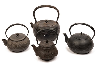 Lot 1087 - A collection of four Japanese cast metal teapots