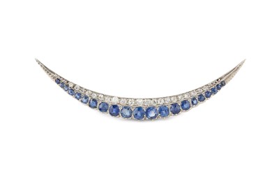 Lot 352 - A sapphire and diamond crescent brooch, set...