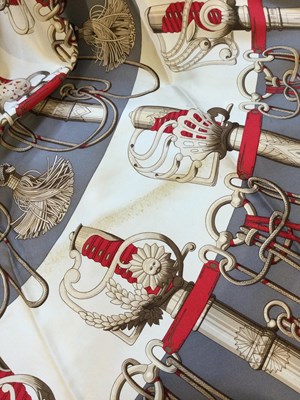 Lot 574 - A 'Cliquetis' silk scarf by Hermès, designed...