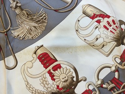 Lot 574 - A 'Cliquetis' silk scarf by Hermès, designed...