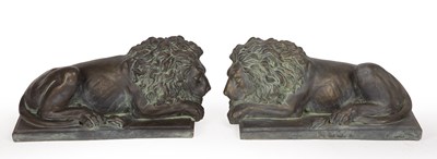 Lot 1384 - A pair of decorative recumbent lion ornaments